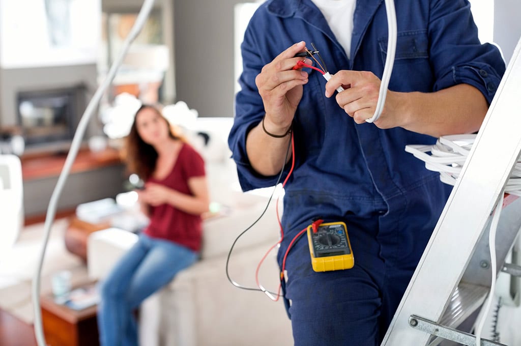 Un électricien installateur déplace une prise